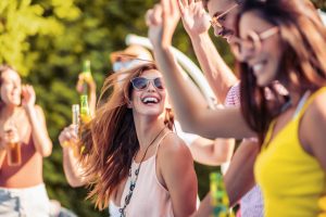 How to deal with a hangover? Hangover tips. A group of people celebrating and drinking.