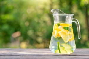 What to drink when you have a hangover - water, in a jug with slices of fresh lemon