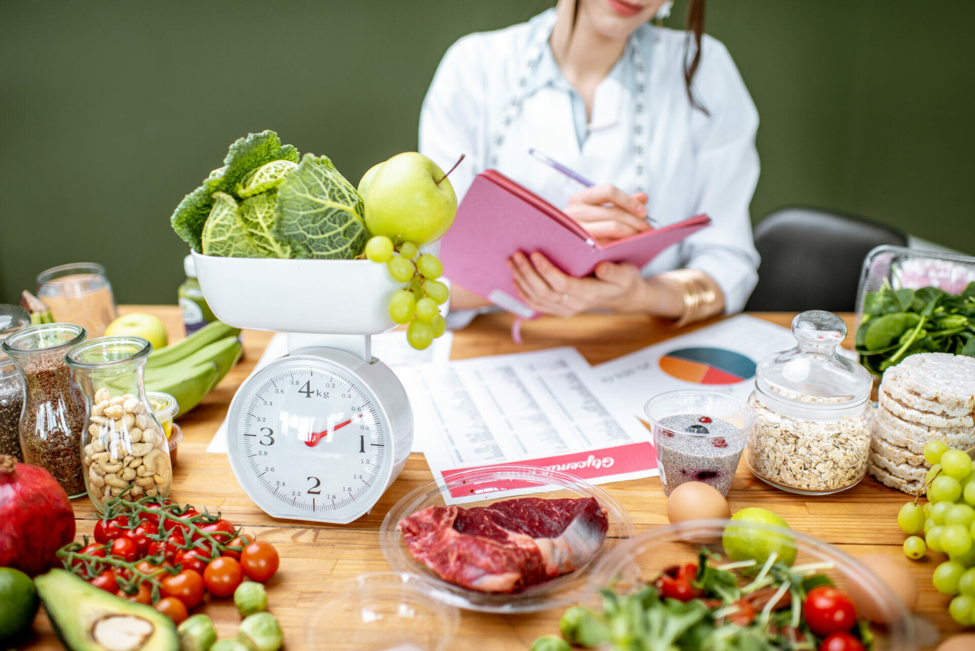 Dietitian surrounded by healthy food, making a gut health nutrition plan in the office