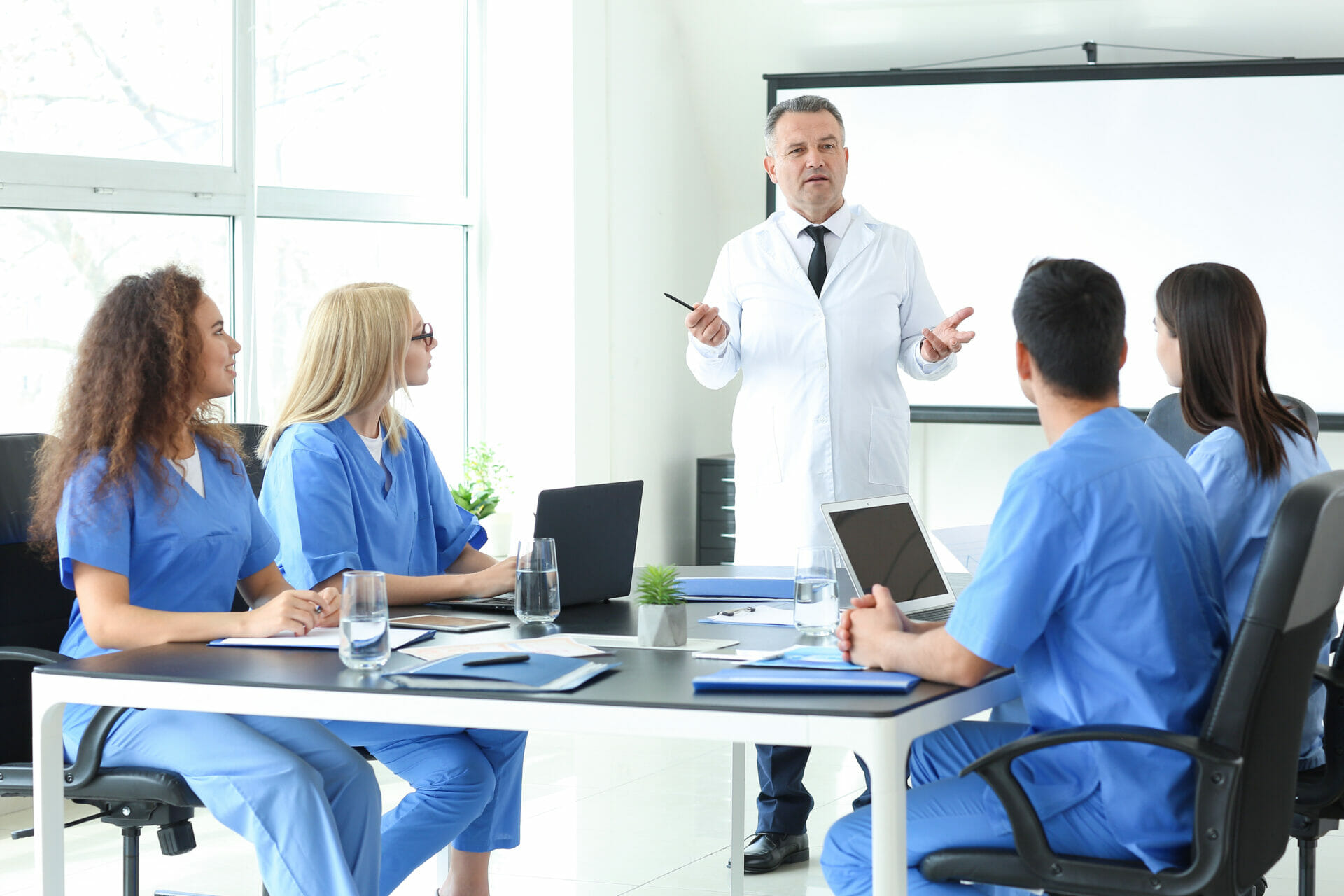 Male lecturer teaching medical students in university