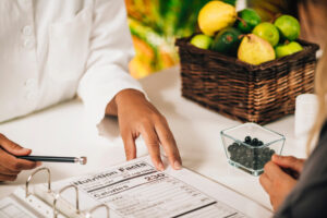 Nutritionist explaining nutrition facts label to a client, close-up