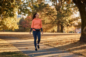 A female smiling taking a walk in the autumn