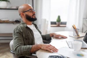 Man taking ten minute mental break at the desk for good health.