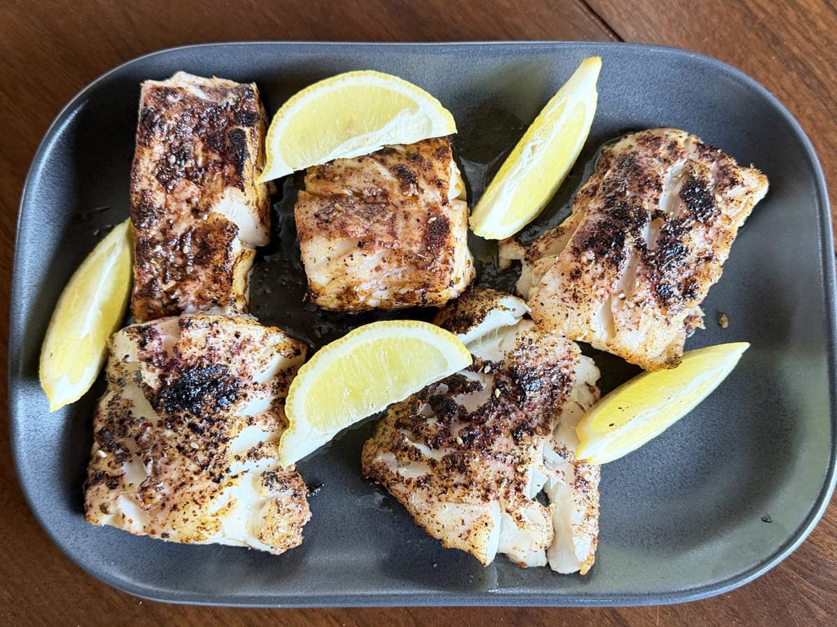 Roasted Cod with Sumac and Za'atar garnished with lemon wedges
