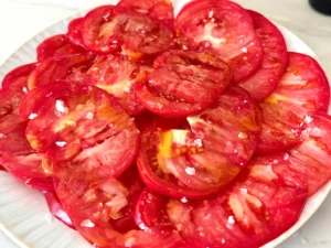 a plate of Tomato Carpaccio seasoned with salt